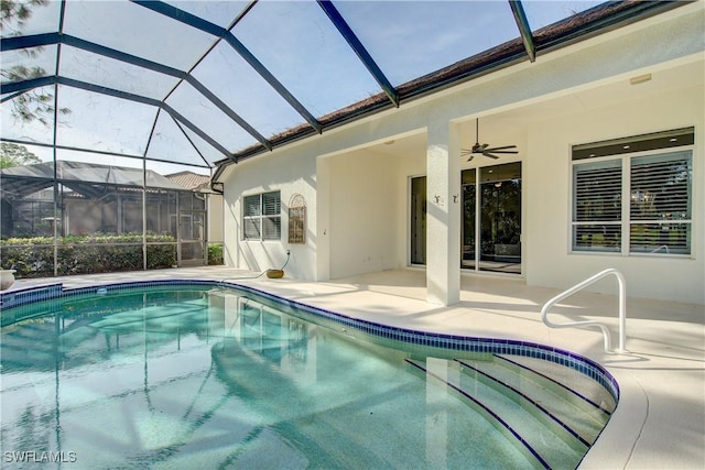 view of swimming pool featuring ceiling fan, a patio area, and a lanai