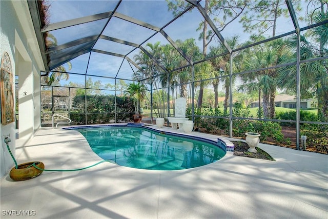 view of swimming pool with glass enclosure and a patio