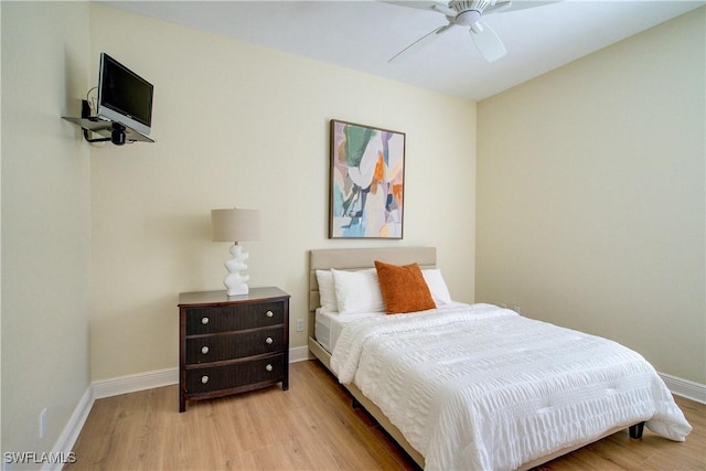 bedroom with ceiling fan and light hardwood / wood-style floors