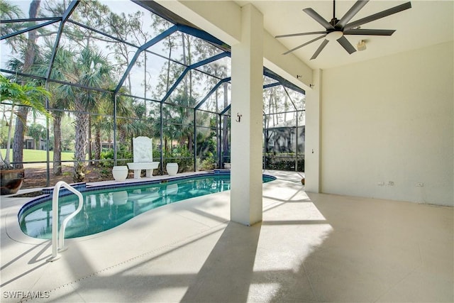 view of pool with a lanai, ceiling fan, and a patio