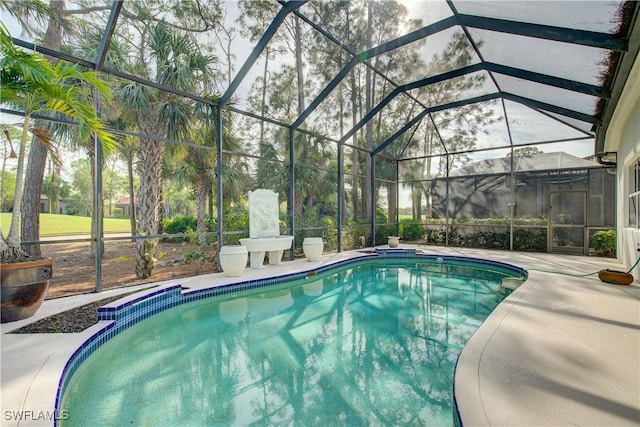 view of pool featuring glass enclosure and a patio area