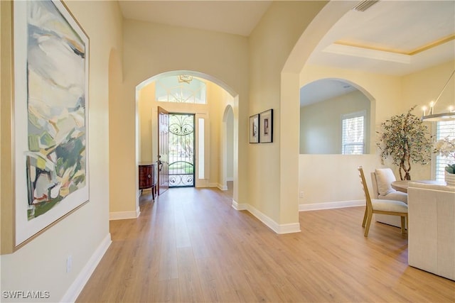 entrance foyer featuring a chandelier and light wood-type flooring