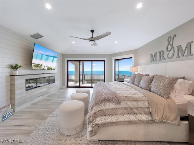 bedroom with access to outside, ceiling fan, and light wood-type flooring