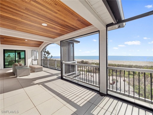 exterior space with a water view and a beach view