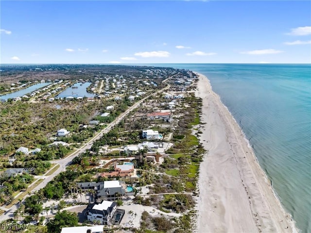 drone / aerial view featuring a view of the beach and a water view