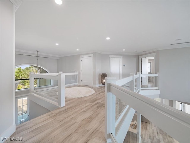 hall featuring light hardwood / wood-style floors and ornamental molding