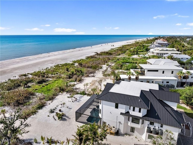 birds eye view of property with a beach view and a water view