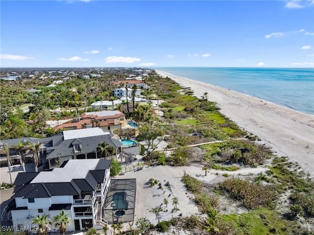 drone / aerial view featuring a view of the beach and a water view