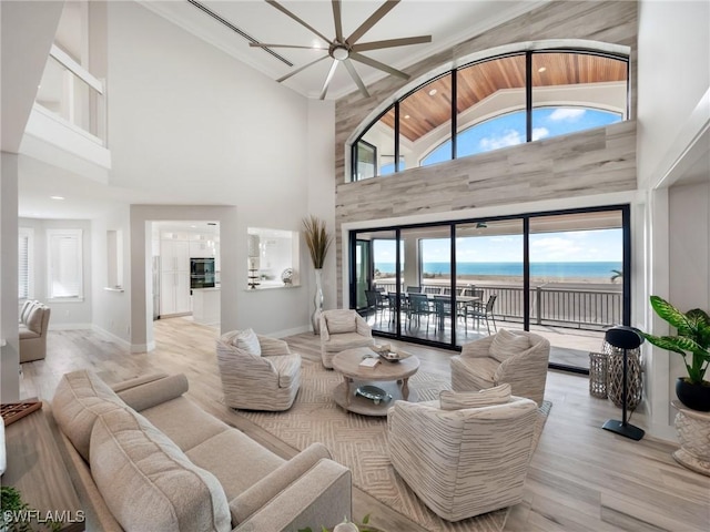 living room featuring ceiling fan, wooden ceiling, light hardwood / wood-style flooring, high vaulted ceiling, and a water view