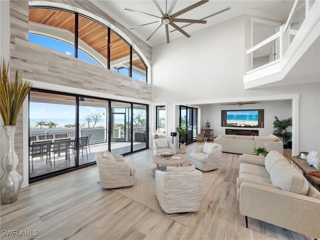 living room with ceiling fan, light wood-type flooring, wooden ceiling, and high vaulted ceiling