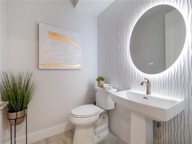 bathroom featuring hardwood / wood-style floors and toilet