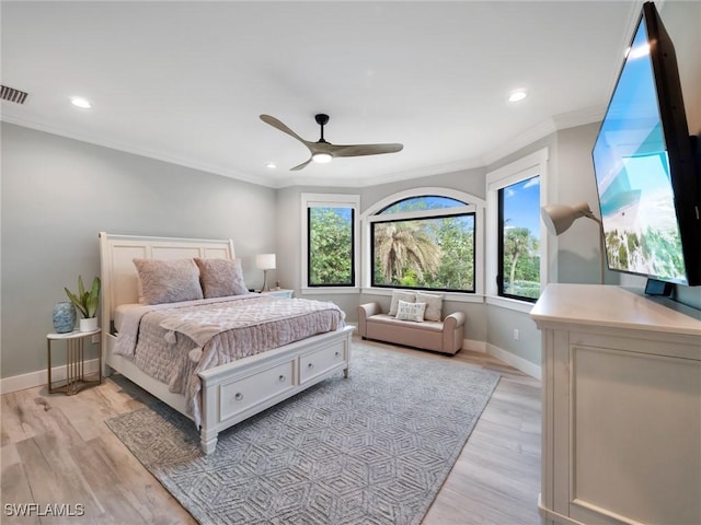 bedroom with ceiling fan, light wood-type flooring, and ornamental molding