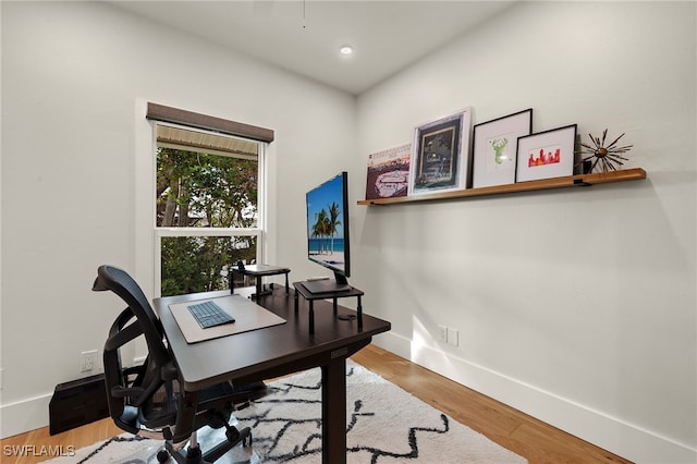 office featuring recessed lighting, wood finished floors, and baseboards