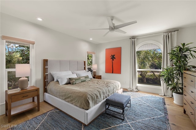 bedroom featuring light wood finished floors, a ceiling fan, and recessed lighting