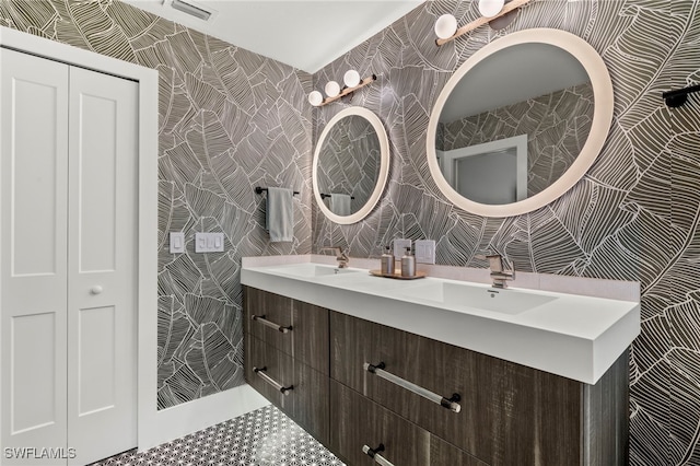 full bath featuring a sink, tile walls, and double vanity