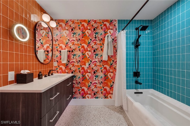 bathroom featuring vanity, shower / bath combination with curtain, and speckled floor