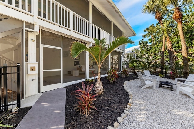 view of yard with an outdoor fire pit, a patio, and a balcony