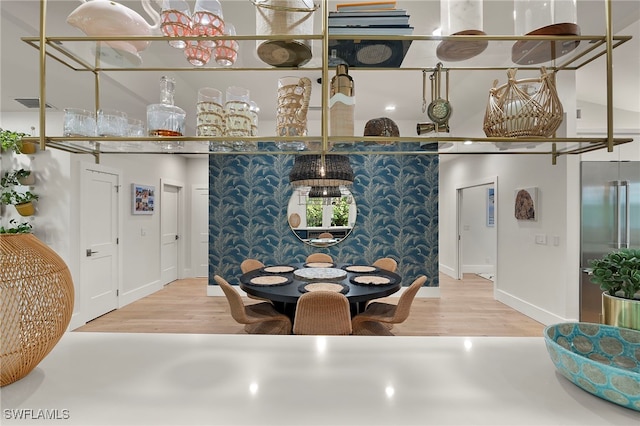 dining room featuring visible vents and wood finished floors