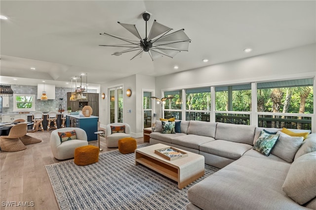 living area featuring an inviting chandelier, wood finished floors, and recessed lighting