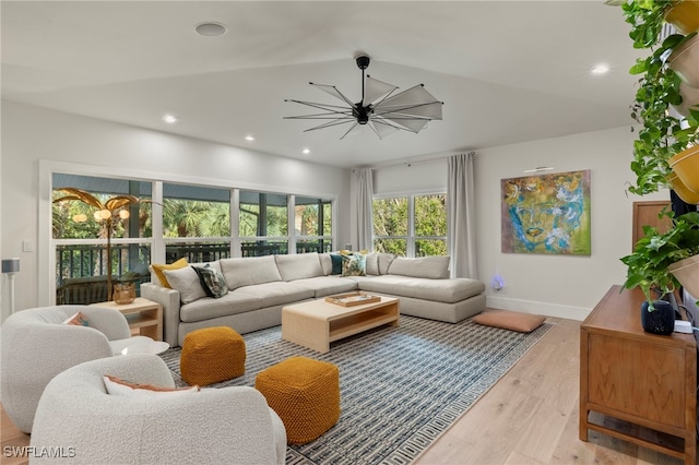 living room featuring recessed lighting, baseboards, and wood finished floors