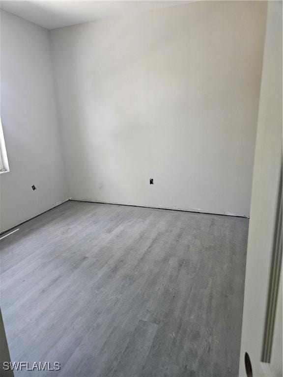 unfurnished room featuring hardwood / wood-style floors