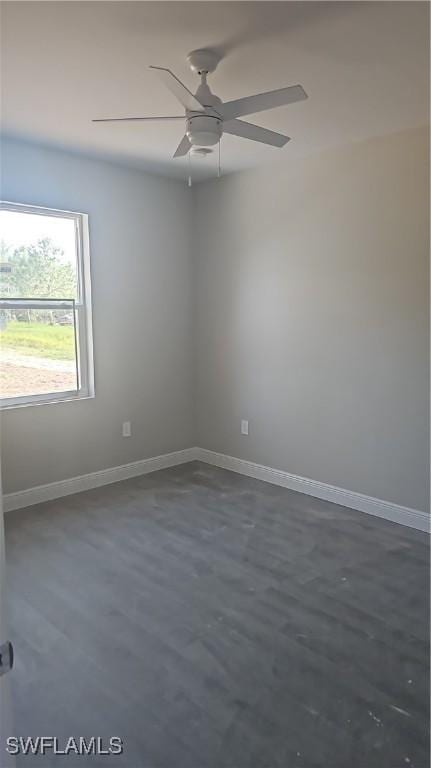 3019 32nd St W, Lehigh Acres, FL 33971 - unfurnished room featuring ceiling fan, baseboards, and concrete flooring
