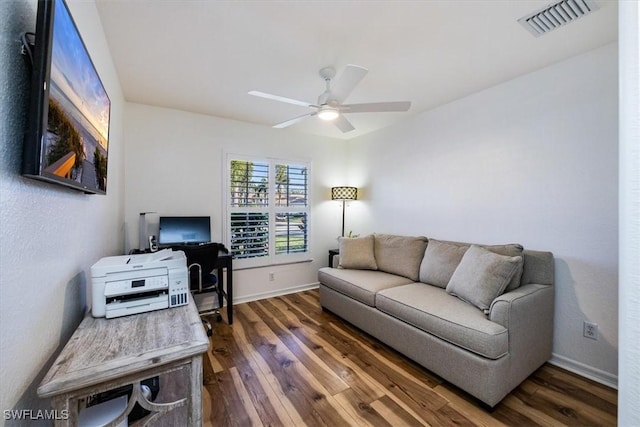 living room featuring dark hardwood / wood-style flooring and ceiling fan