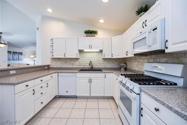 kitchen with white appliances, white cabinetry, and vaulted ceiling