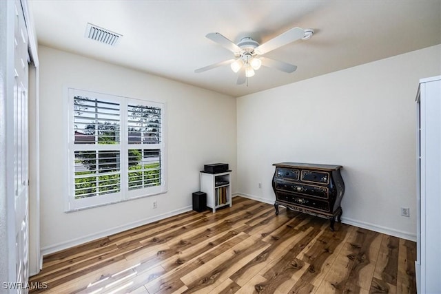 misc room with dark hardwood / wood-style floors and ceiling fan