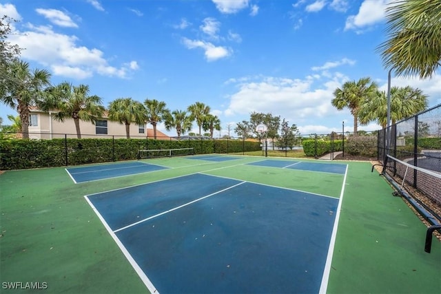 view of tennis court featuring basketball hoop