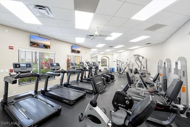 gym featuring a paneled ceiling and ceiling fan