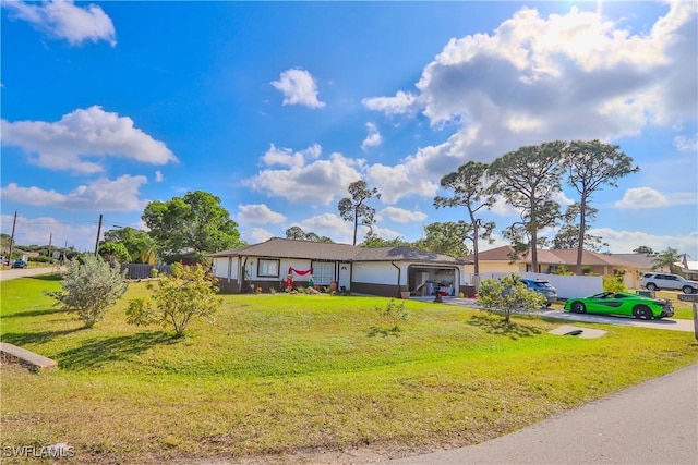 ranch-style house featuring a garage and a front yard