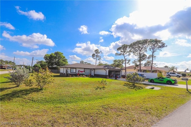 ranch-style house with a garage and a front lawn