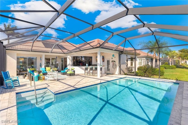 view of swimming pool with glass enclosure, a bar, and a patio