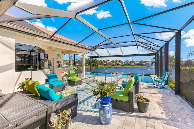 view of patio with outdoor lounge area, a water view, and glass enclosure