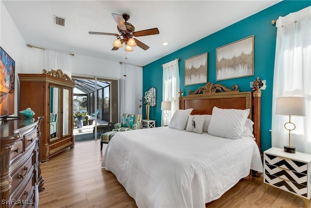 bedroom with hardwood / wood-style floors, ceiling fan, and access to outside