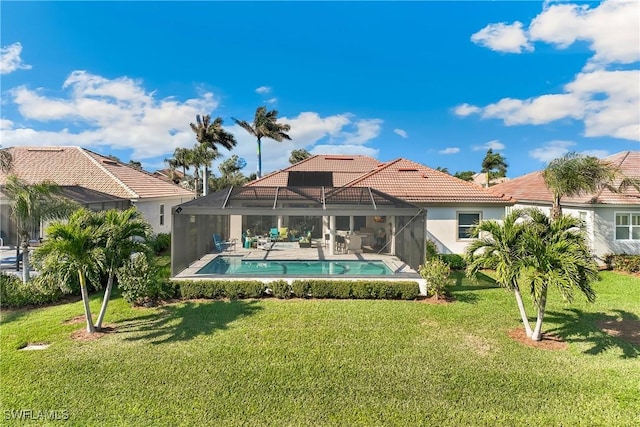 back of property featuring a patio area, a lanai, and a lawn