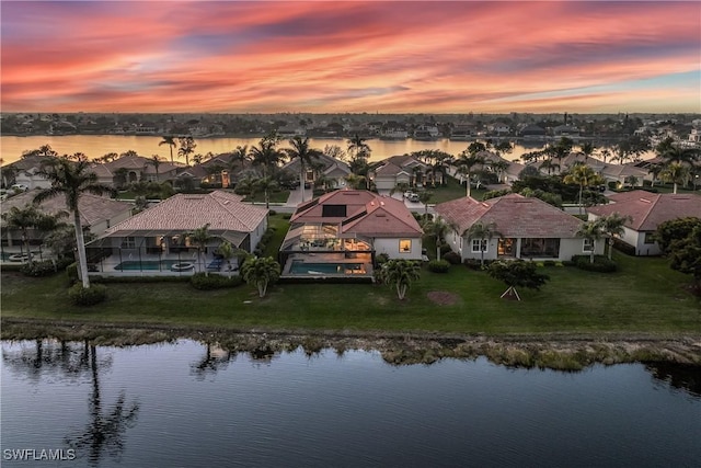 aerial view at dusk with a water view