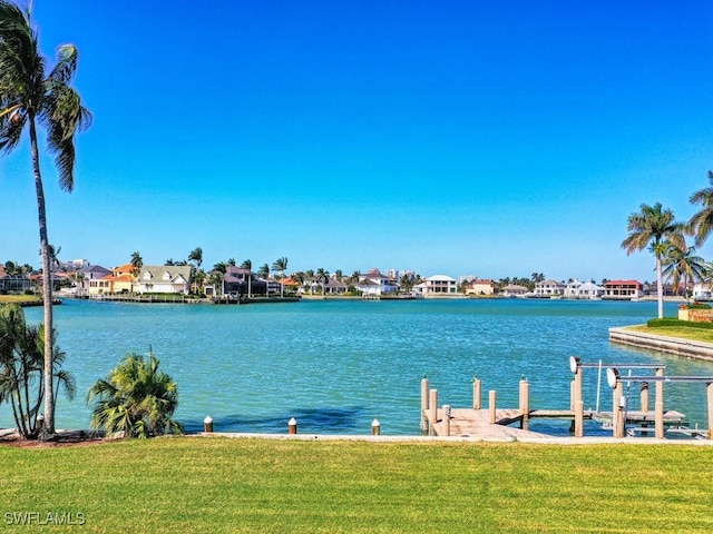 dock area featuring a yard and a water view