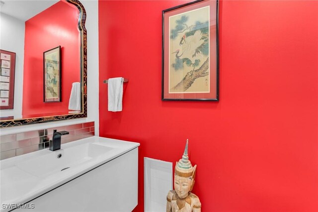 bathroom featuring vanity and backsplash