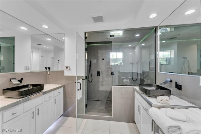 bathroom with a shower with door and vanity