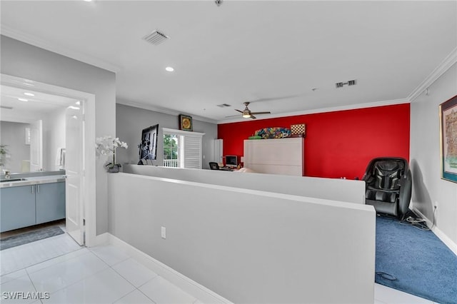 interior space featuring light tile patterned floors, ceiling fan, ornamental molding, and sink