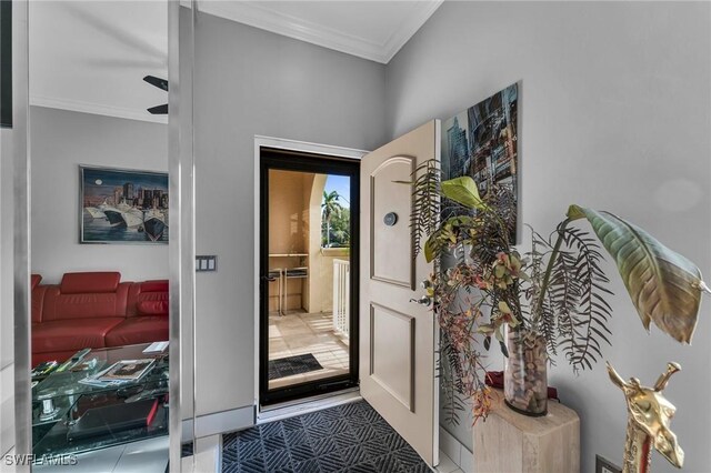 interior space with ceiling fan and crown molding