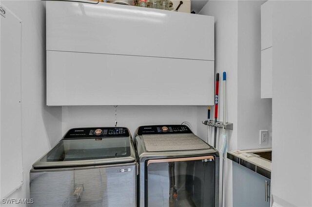 clothes washing area featuring washing machine and clothes dryer