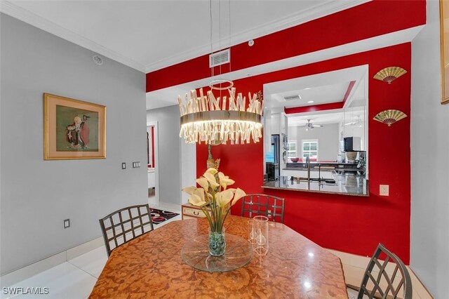 tiled dining room featuring crown molding and ceiling fan