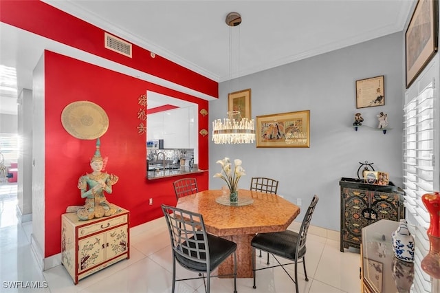 dining room with a healthy amount of sunlight, light tile patterned floors, and crown molding