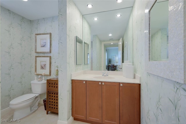 bathroom featuring vanity, tile patterned floors, and toilet