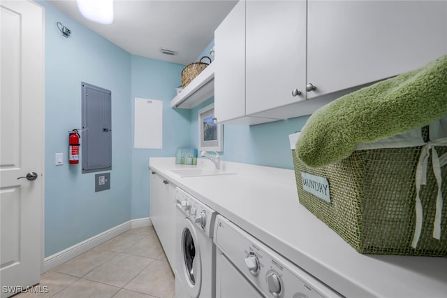 laundry area featuring washing machine and clothes dryer, sink, cabinets, light tile patterned floors, and electric panel