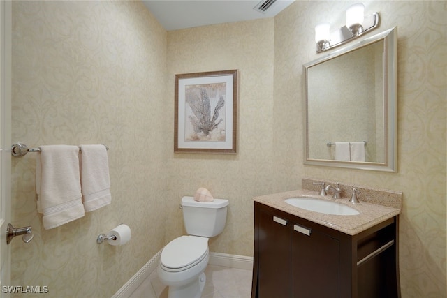 bathroom with vanity, tile patterned flooring, and toilet