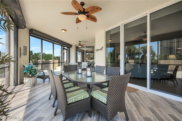 sunroom / solarium featuring ceiling fan